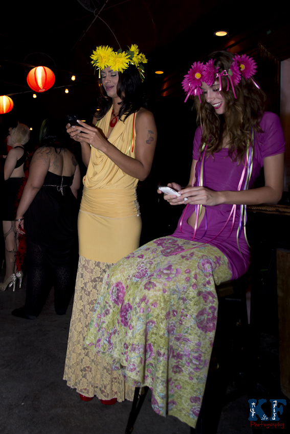 Models, Delila Hart and Kimberley Hall waiting for fashion show to begin, texting their friends to attend the show